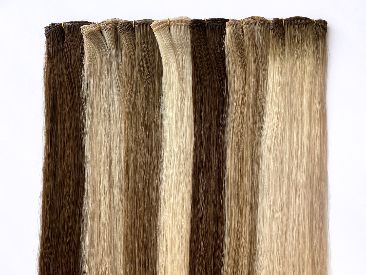 KOVI Hair Microwefts lined up in alternating colors. The mircowefts are made from 100% Remy human hair. 