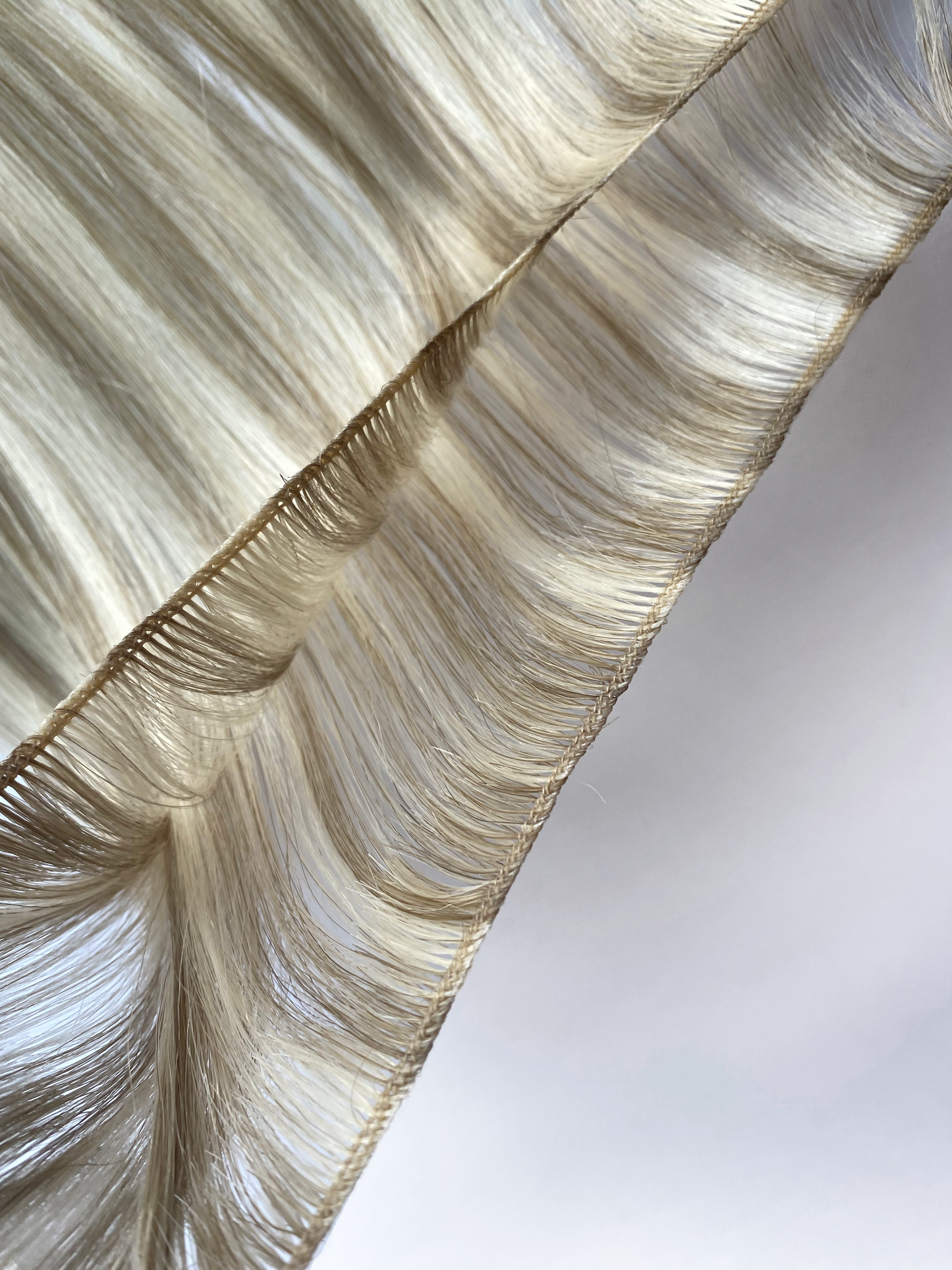 Open bundle of 22" inch remy human hair micro weft extensions.